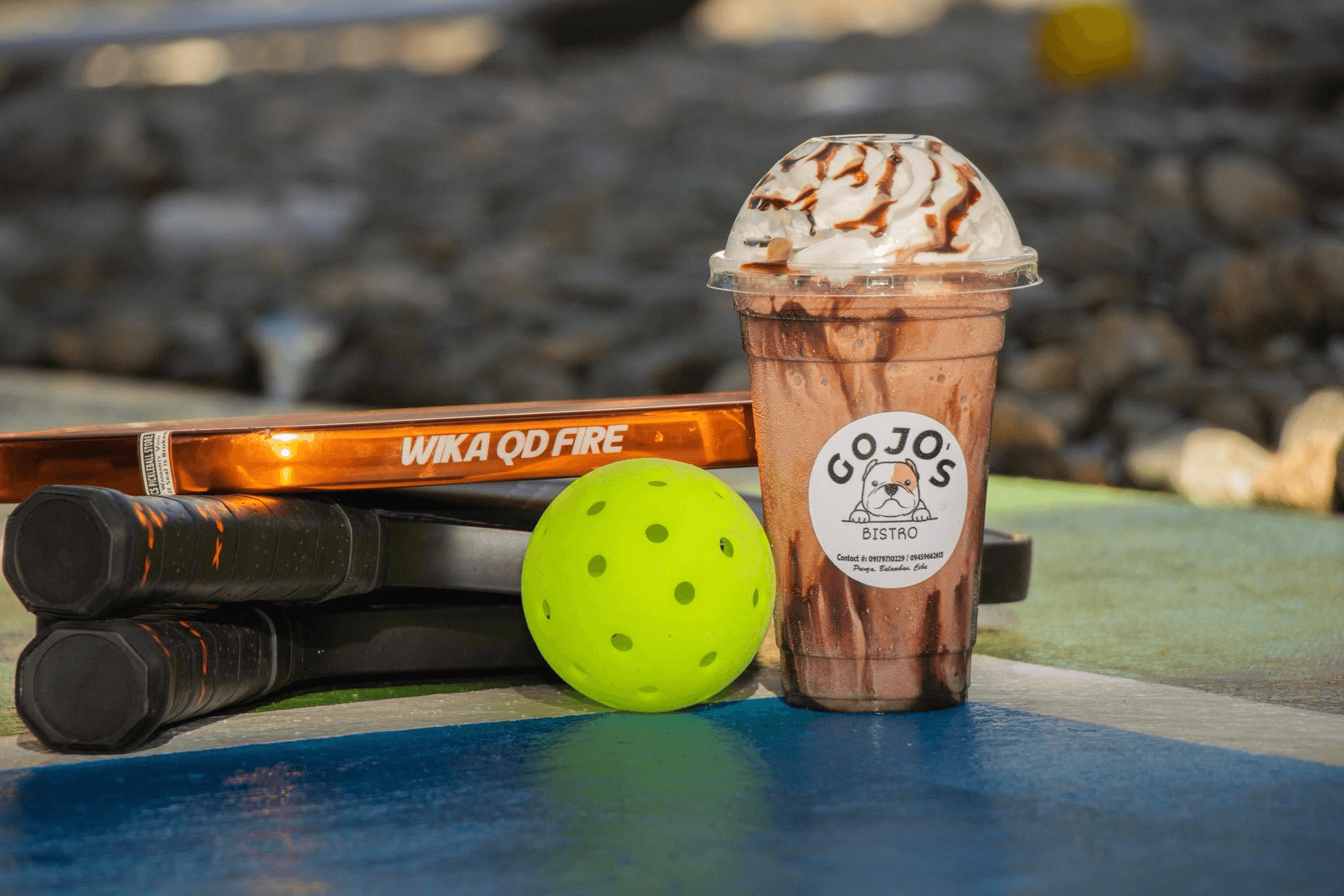 Pickleball paddles and ball at Gojo's Bistro